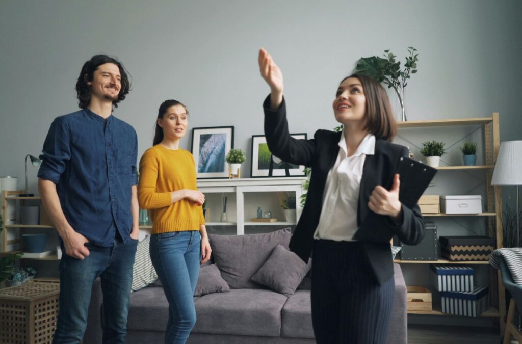 An employee of Scotty Cash Buys Houses reviewing repair-free home sale paperwork with a homeowner in Shannon Hills, AR.